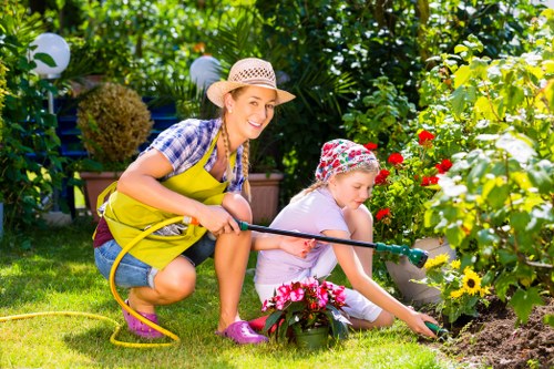 Worker wearing PPE while operating a mower