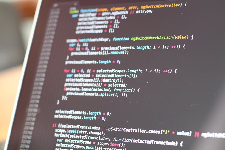 A close-up image of a computer screen displaying lines of colorful programming code, with text in shades of green, pink, blue, and white on a dark background. The code appears to be JavaScript or simi